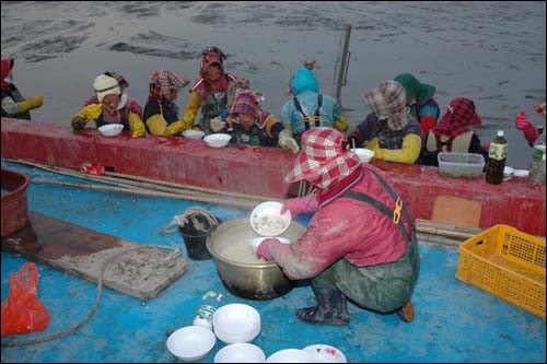 바지선에서 끓인 따끈한 떡국과 '쐬주'가 고된 작업에 잠시 휴식을 준다. 